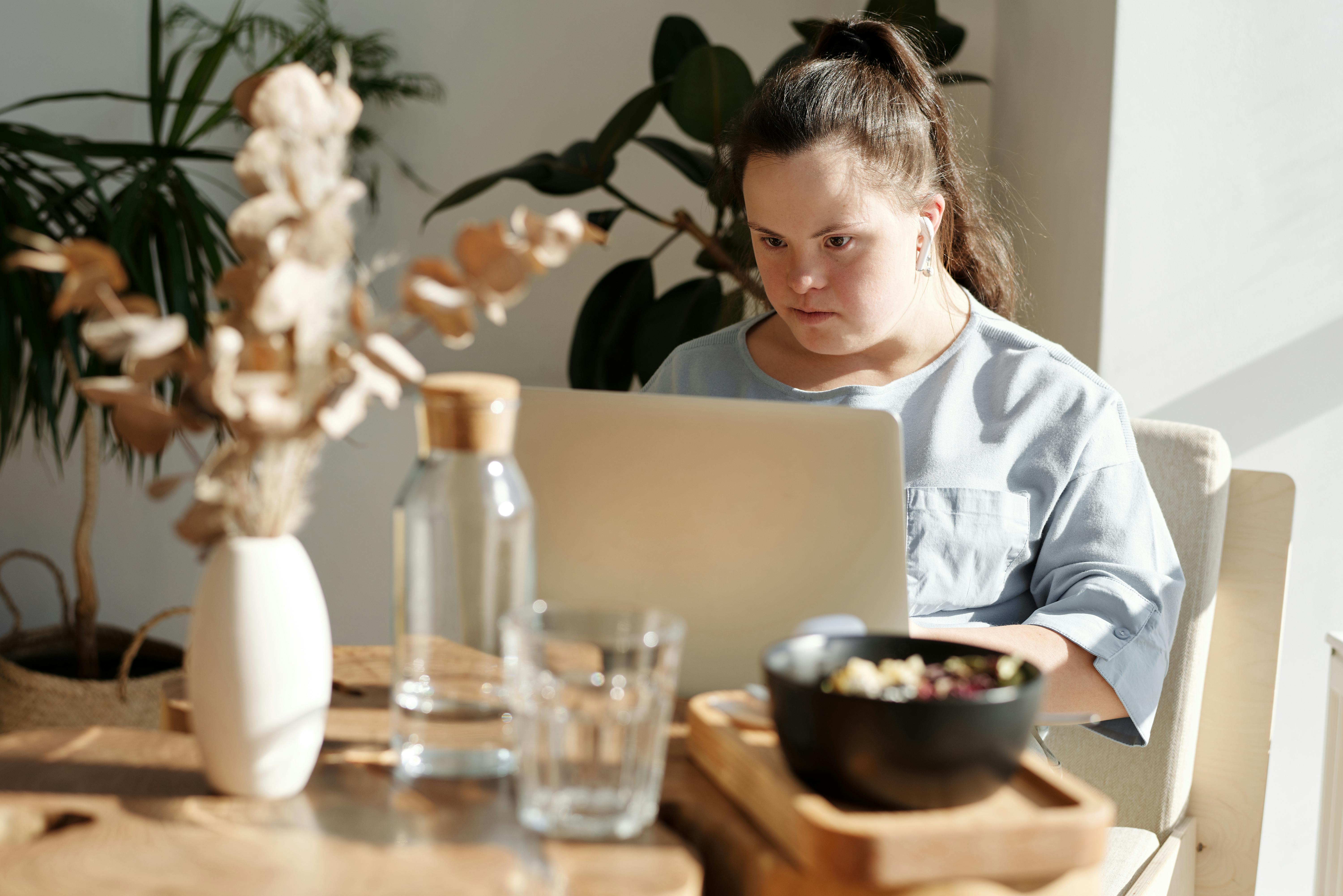 young girl using laptop inside a restaurant