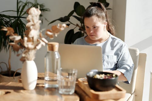 Free Young Girl Using Laptop Inside A Restaurant Stock Photo