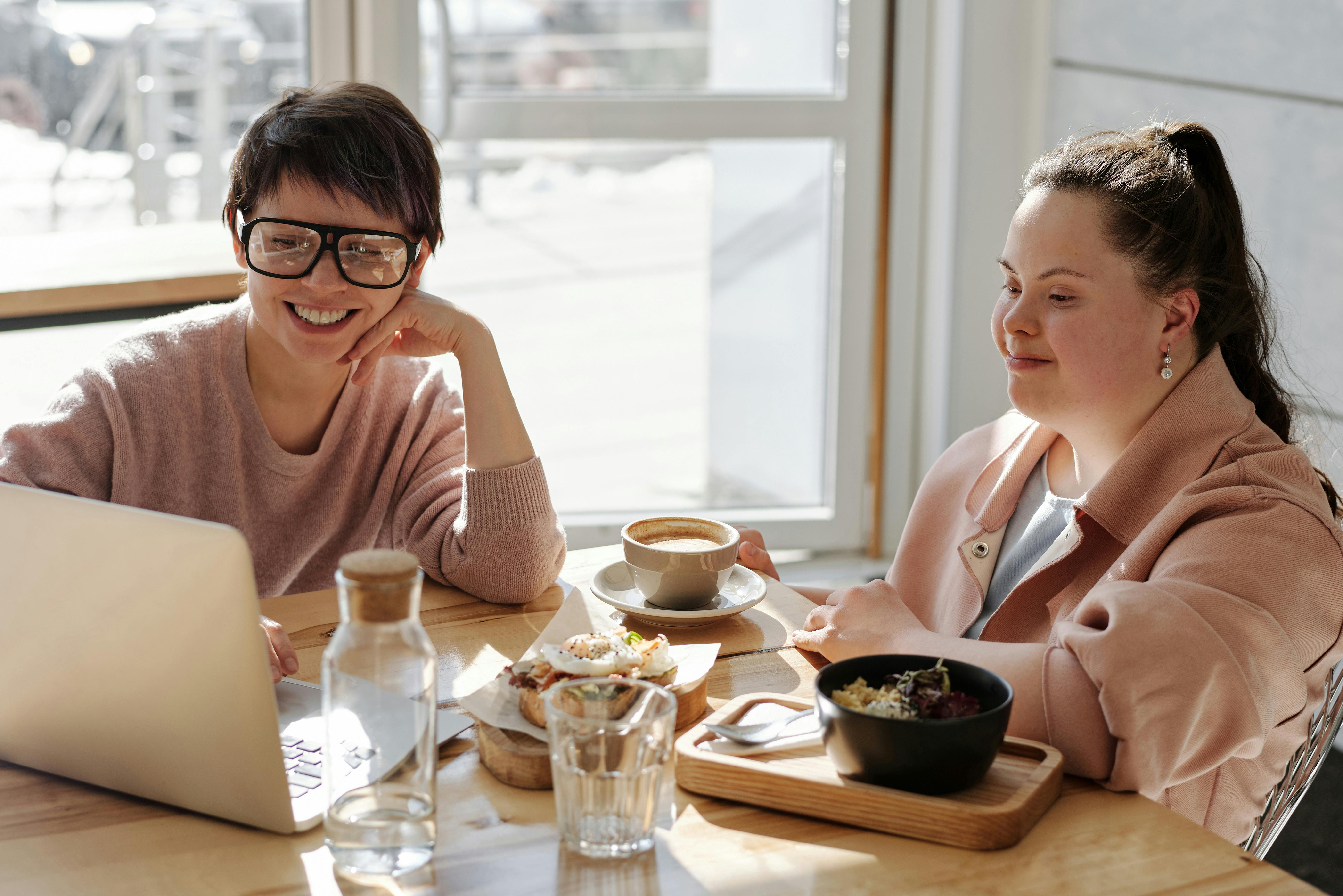 happy young people watching on a laptop