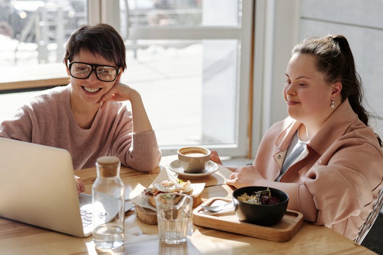 Happy Young People Watching On A Laptop