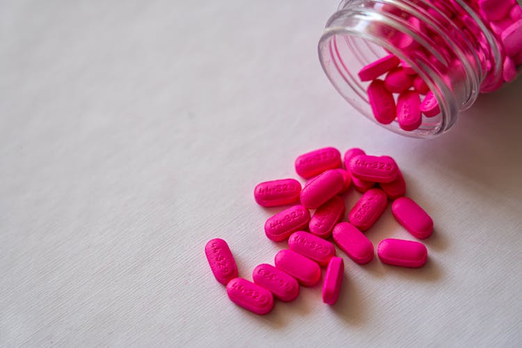 Pink Medication Pills In Clear Glass Jar