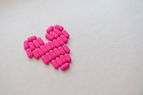 Pink Medication Pill on White Surface
