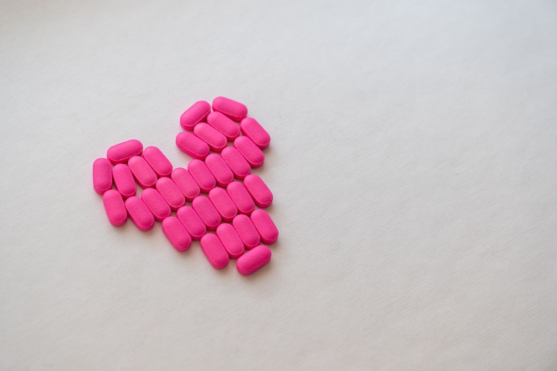 Pink Medication Pink Medication Pill on White Surface · Free Stock Photo