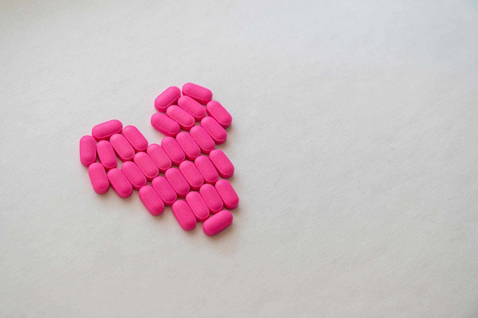 Pink Medication Pill on White Surface