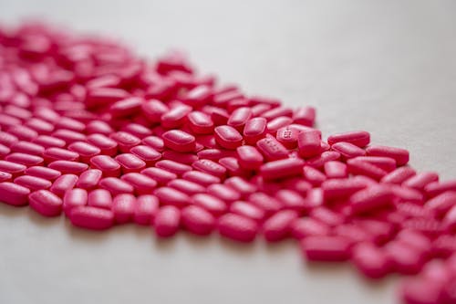 Pink Medicines on White Surface