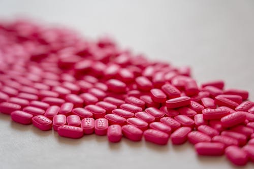 Pink Medicines on White Surface