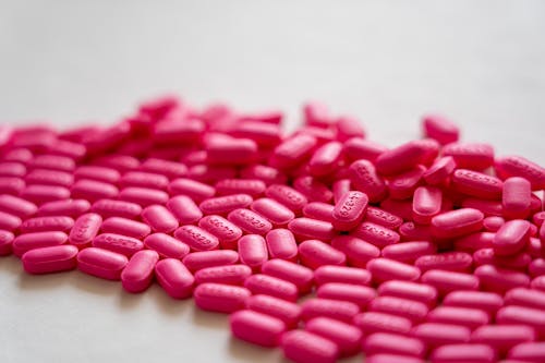 Pink Oval Medication Pills on White Surface