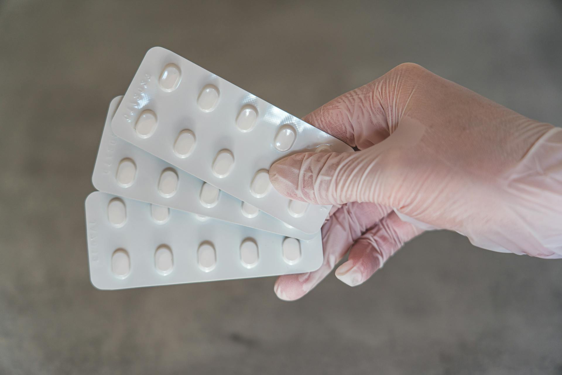 Person Holding White Blister Pack