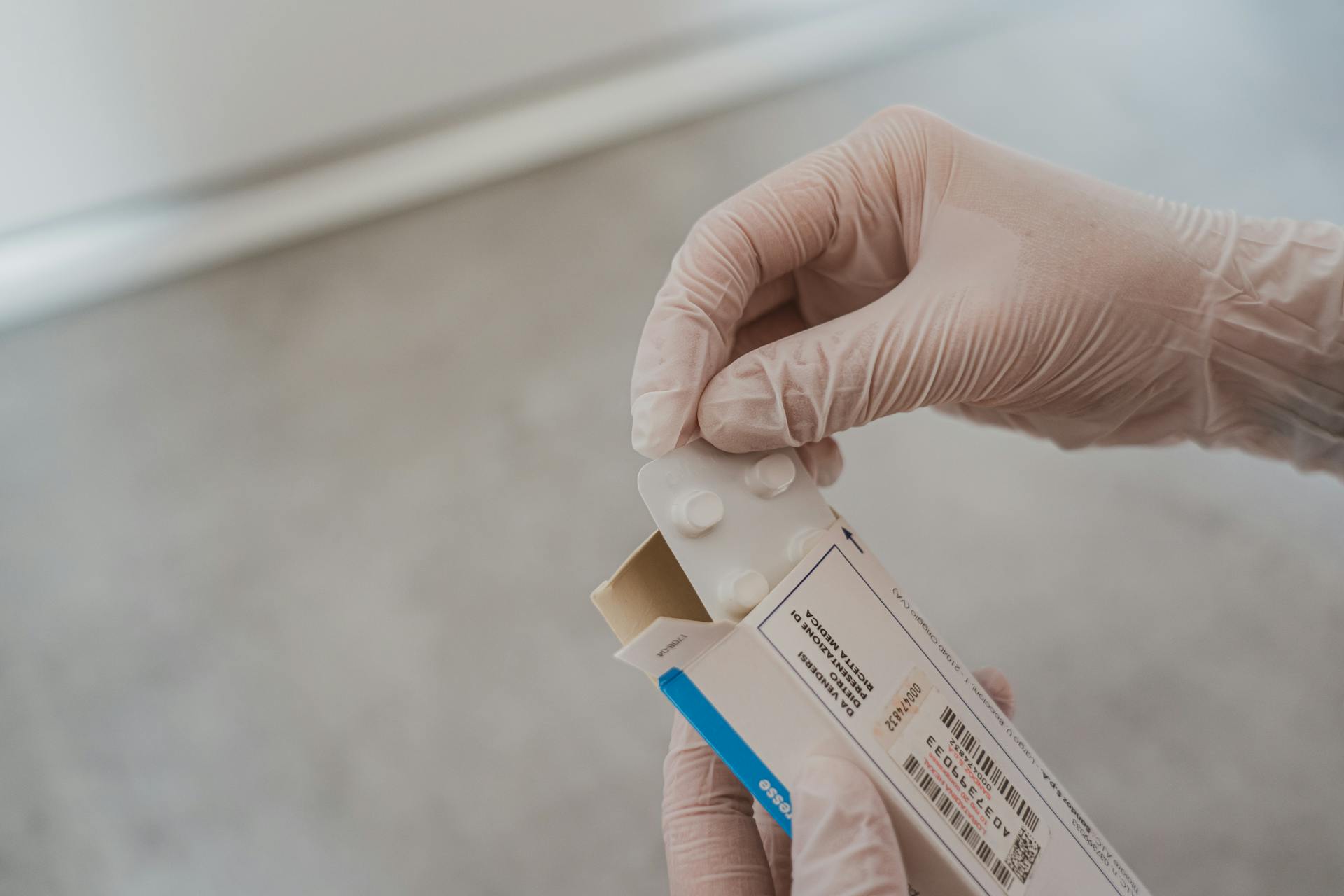 Person Holding White and Blue Box