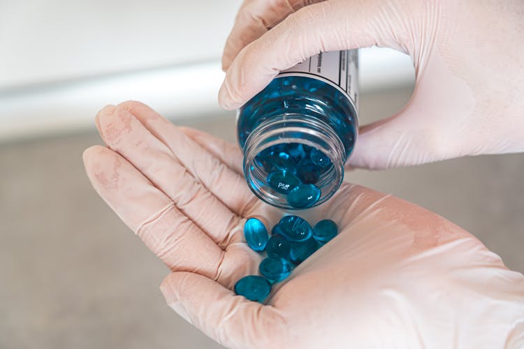 Blue Medication Pill On Persons Hand