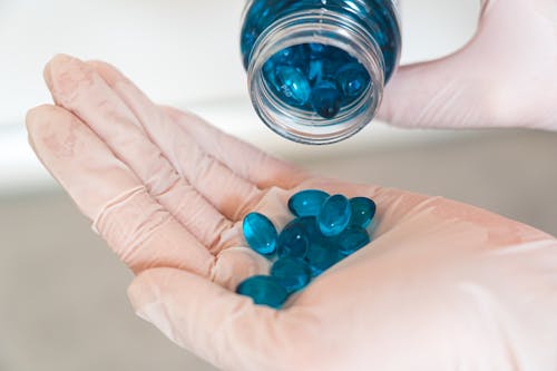 Blue Medication Pill on Persons Hand