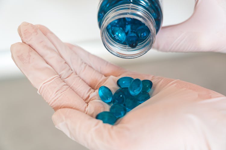 Blue Medication Pill On Persons Hand