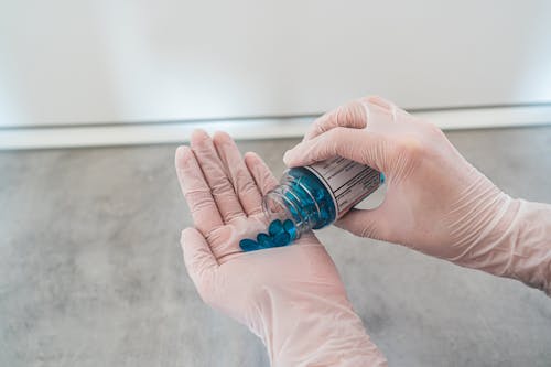 Free Person Holding Blue Pills Stock Photo