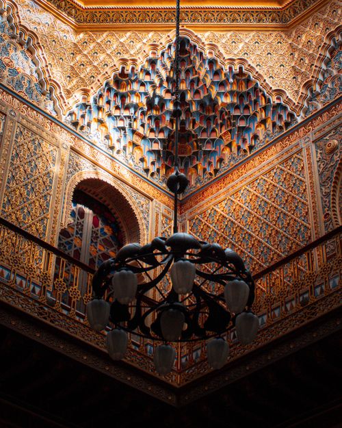Free From below elegant lamp hanging near balcony inside dark building with traditional oriental ornaments Stock Photo