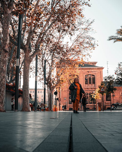 Woman Standing on Sidewalk