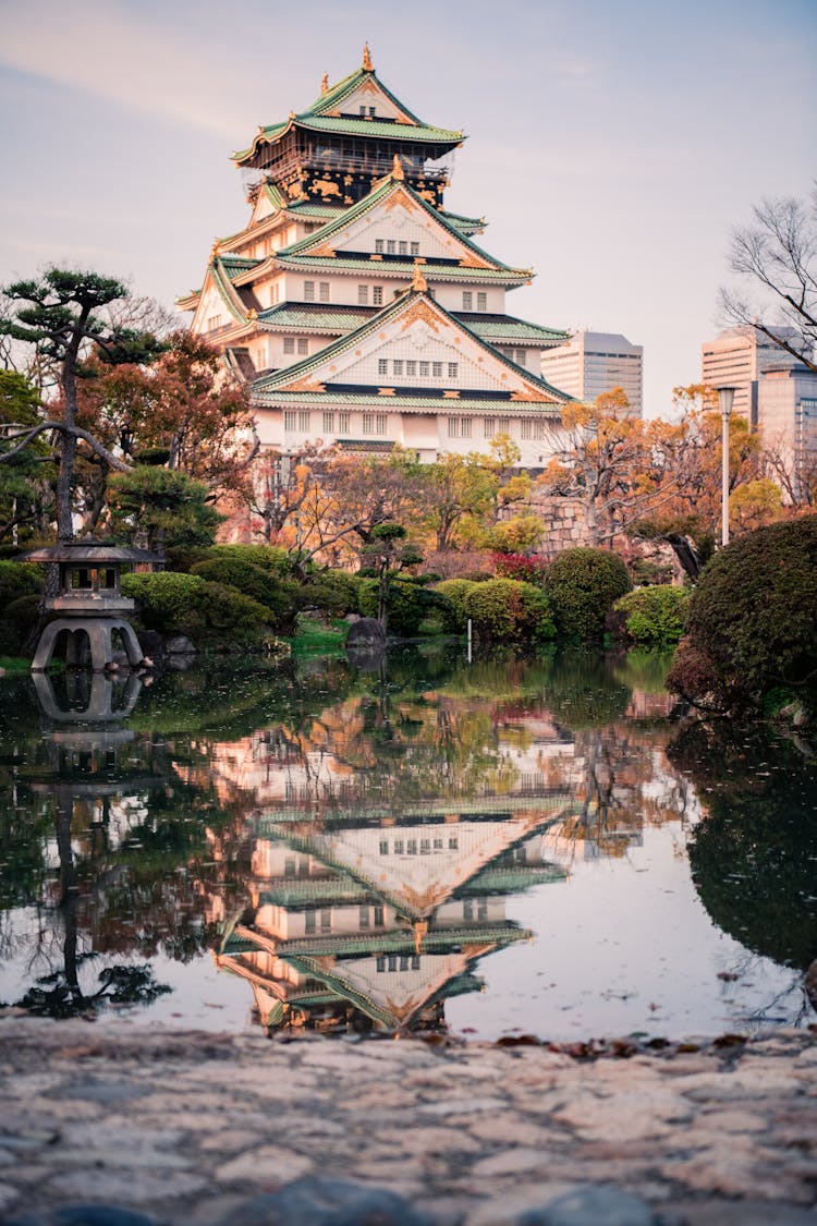 Green And White Castle Building Near Body Of Water