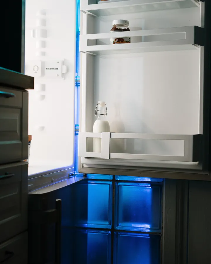 Liebherr refrigerator repair in La Mesa, CA Open refrigerator lit in a home kitchen at night, Liebherr refrigerator repair in La Mesa