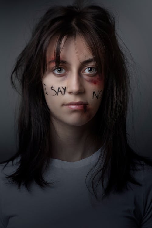 Woman in White Crew Neck Shirt Saying No To Violence