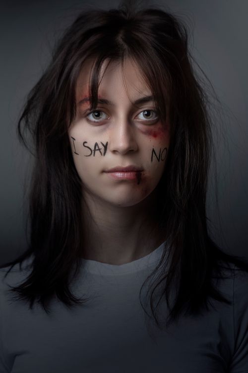Woman in White Crew Neck Shirt Saying No To Violence