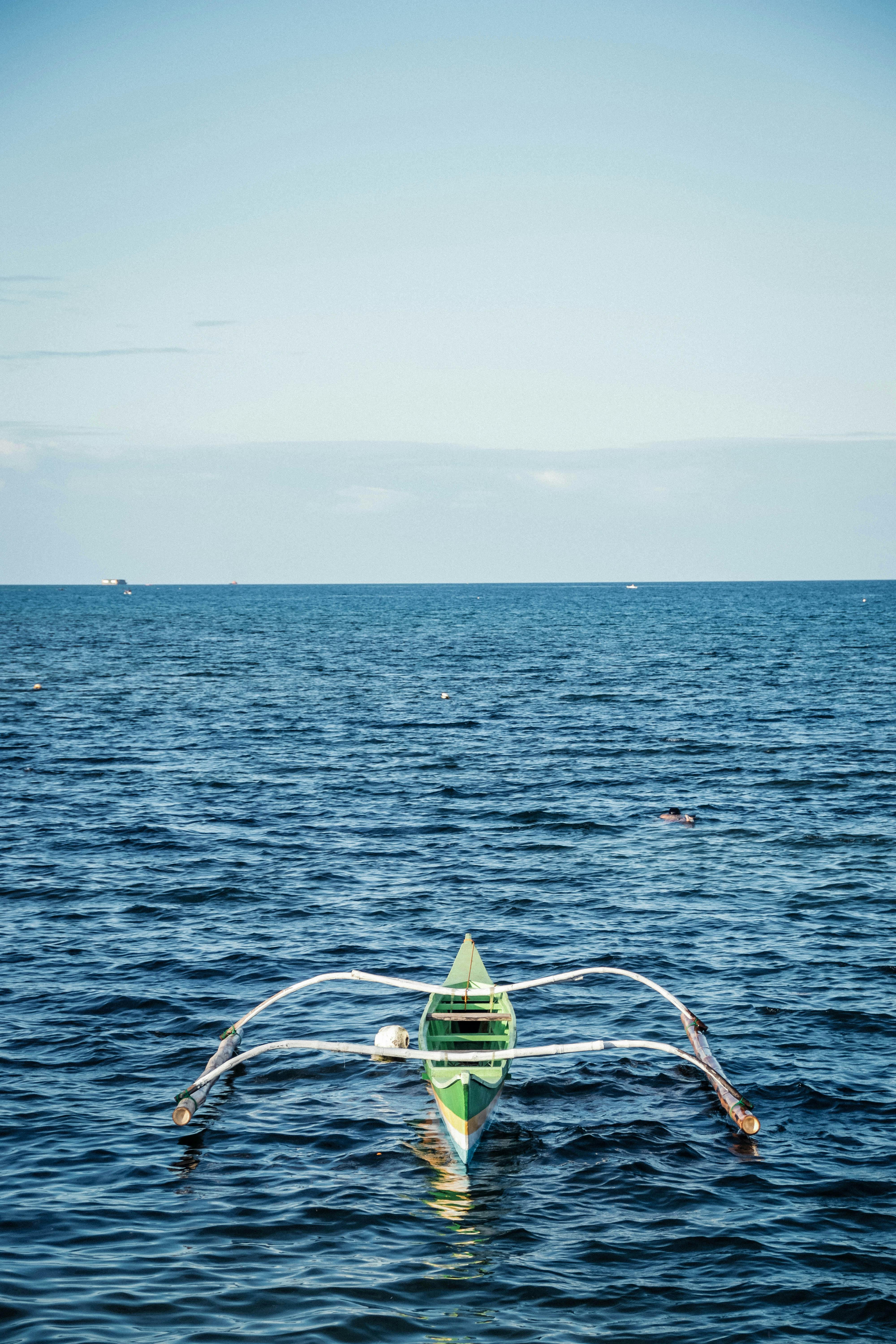 Green And White Boat On Body Of Water · Free Stock Photo