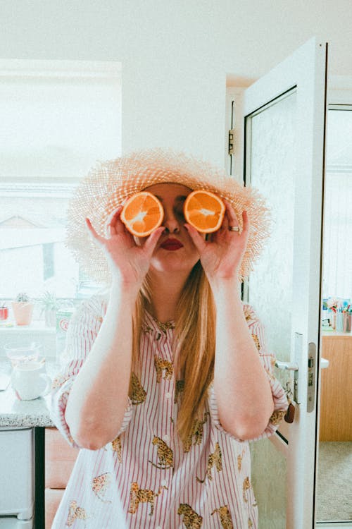Free Woman having fun with citrus at home Stock Photo