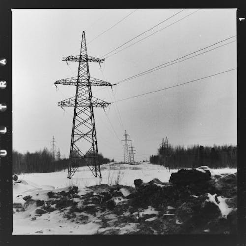 Grayscale Photo of Electric Tower