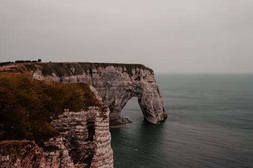 Brown Rock Formation Beside a Body of Water