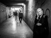 Sad elderly woman standing in passage