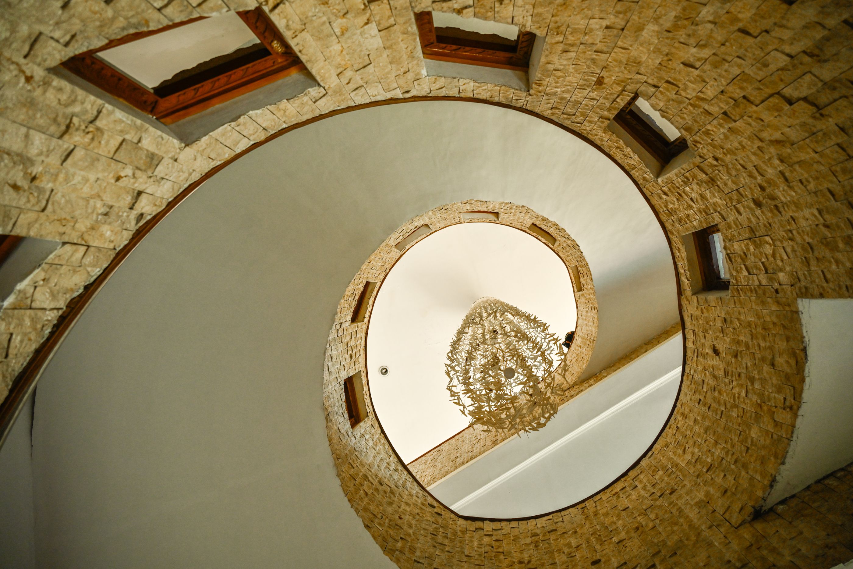Spiral Stone Staircase with Central Chandelier · Free Stock Photo