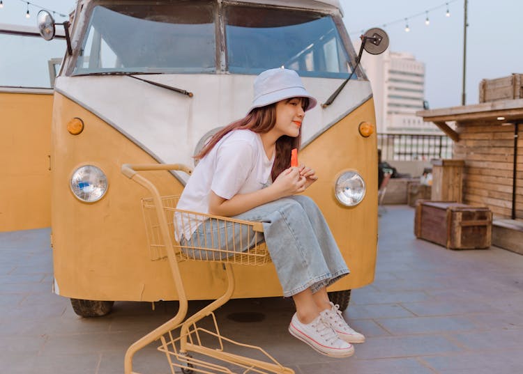 Delighted Asian Female With Watermelon Near Retro Van