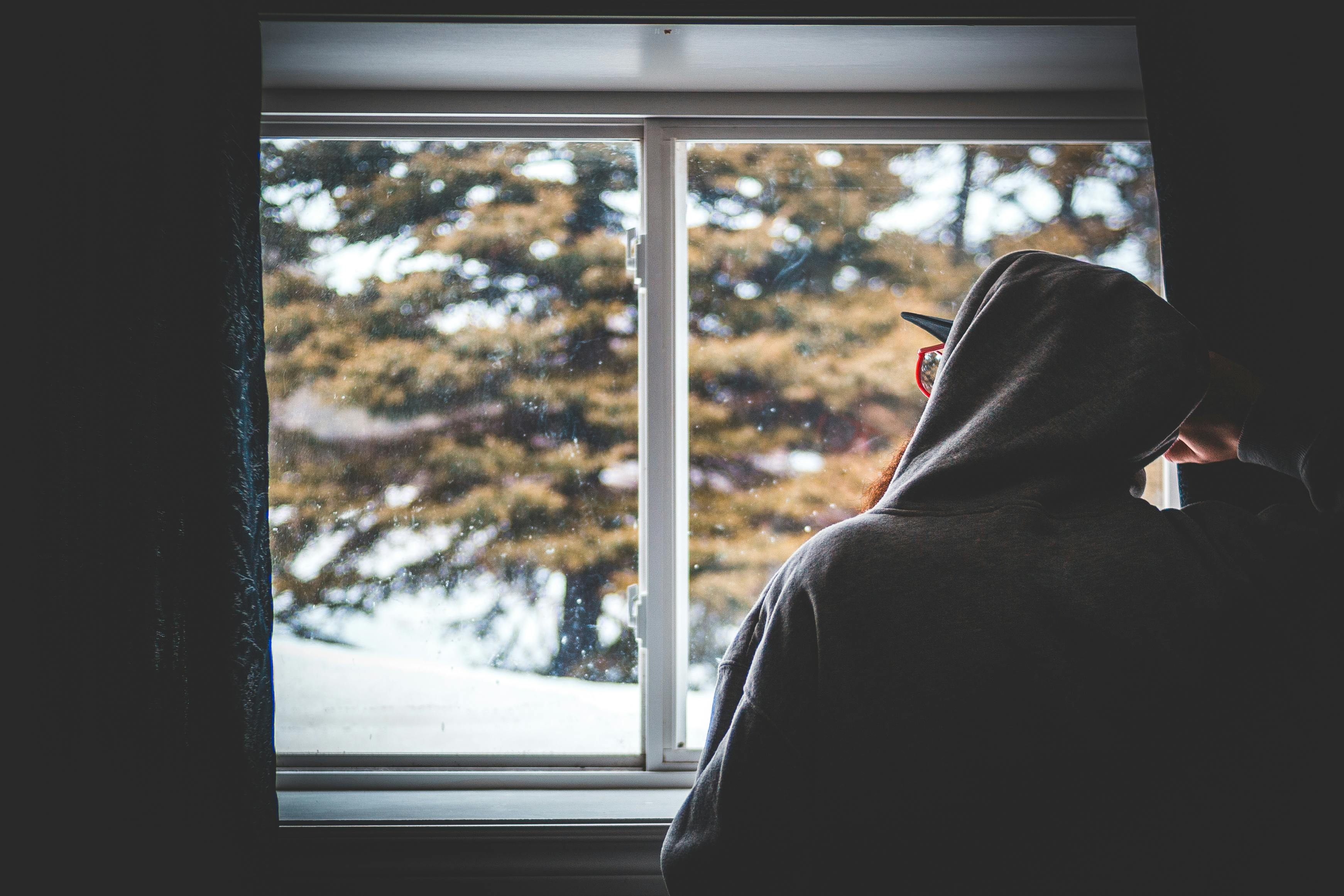 Photo of a Man Looking Outside of His Window · Free Stock Photo