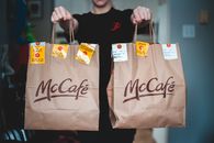 Person Holding Two Paper Bags