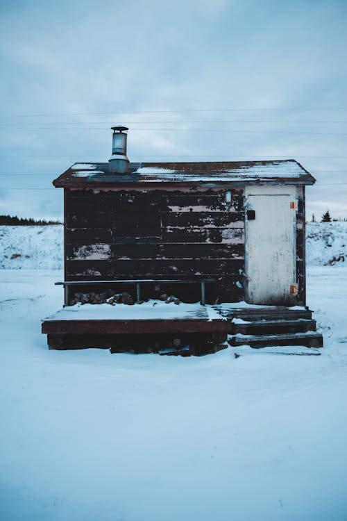 White and Brown Wooden House Covered With Snow