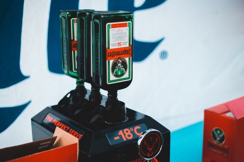 Free Glass bottles of alcohol placed in row in cooling tap machine during trade show Stock Photo