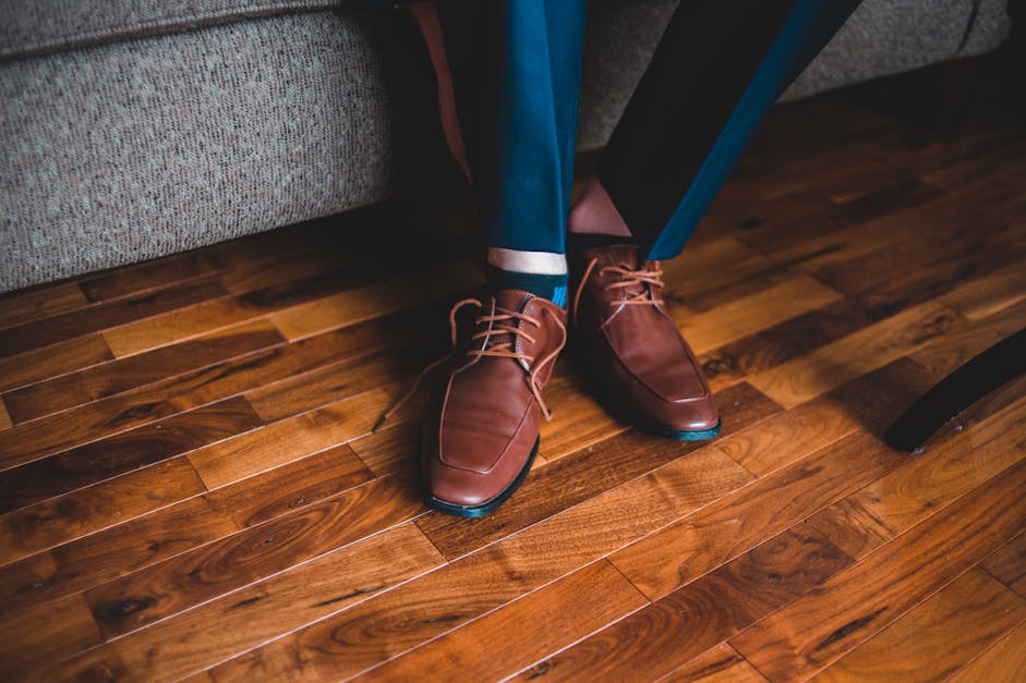 Anonymous man in elegant shoes sitting on sofa · Free Stock Photo