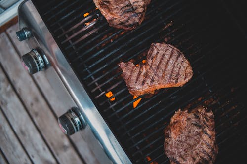 Free Meat frying on grill in yard Stock Photo