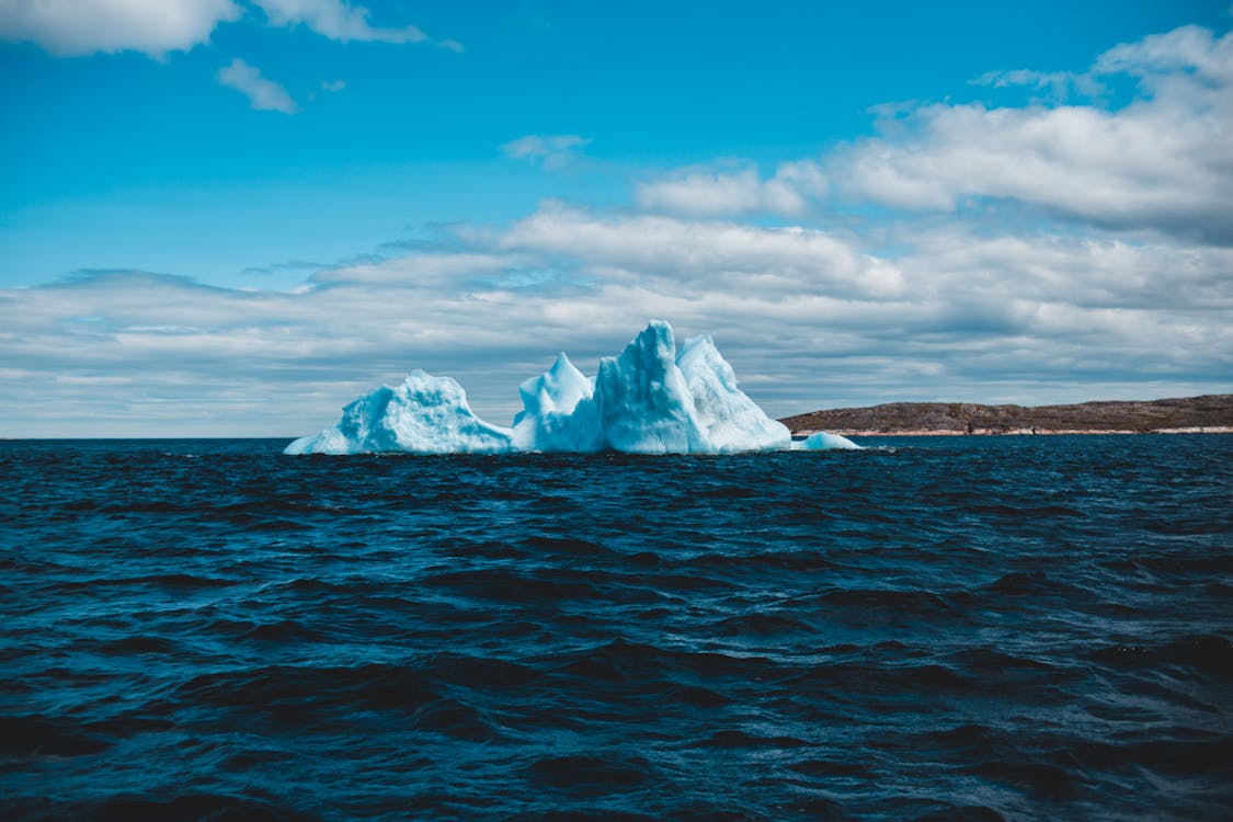 Ice Formation on Body of Water Under Blue Sky