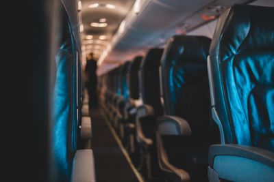 Interior of an empty airplane cabin with leather seats — photo by Erik Mclean on Pexels