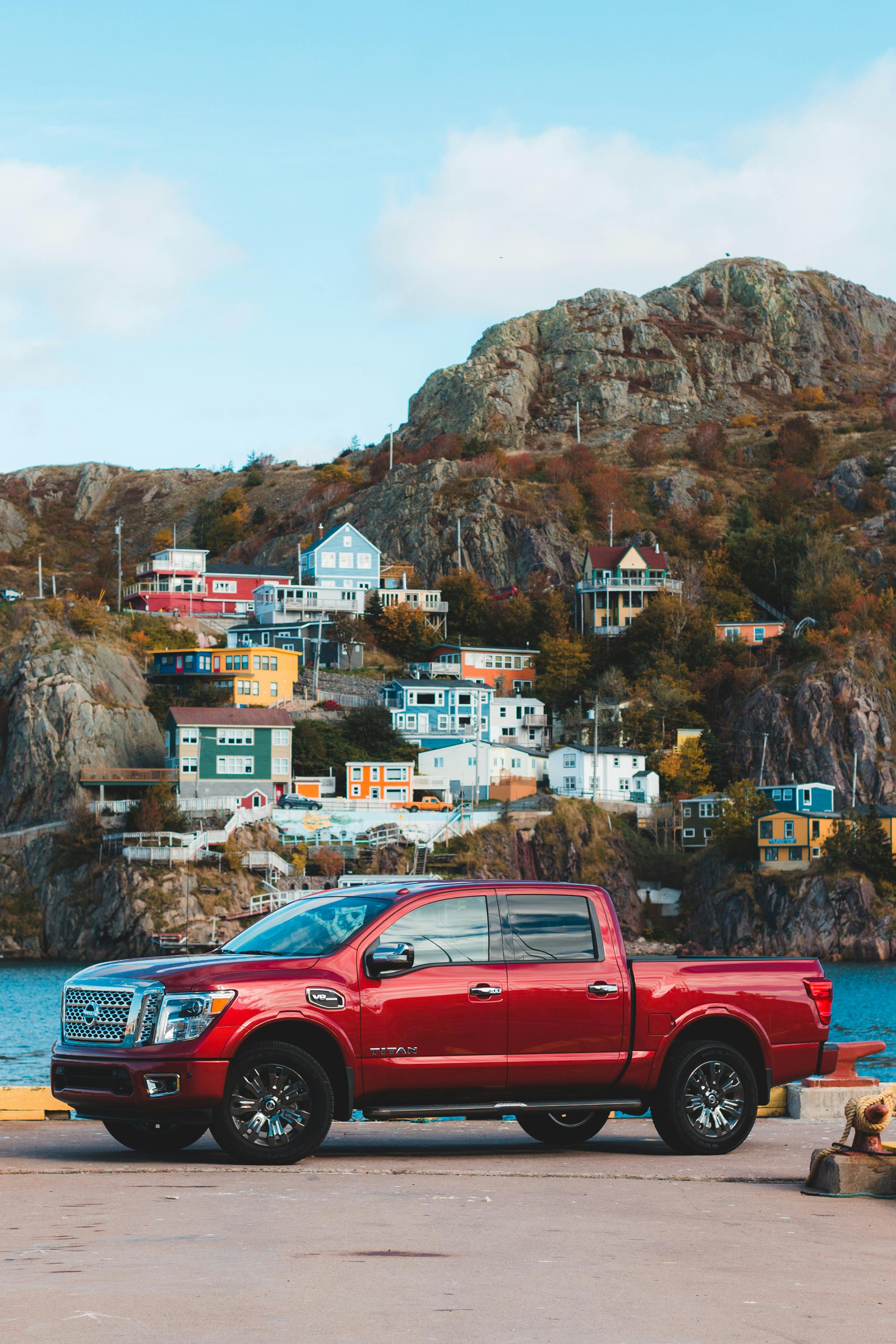 Red Crew Cab Pickup Truck Parked Near Brown Mountain · Free Stock Photo