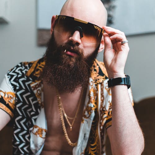 Man in Black and Brown Printed Shirt Wearing Brown Sunglasses