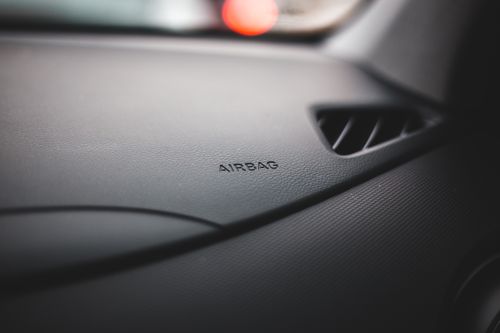 Free Close-up view of the airbag sign on a modern car dashboard indicating safety features. Stock Photo