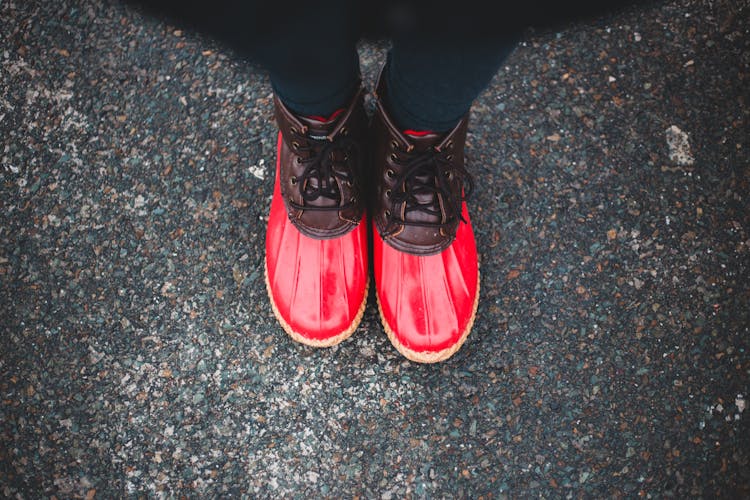 Crop Person In Colorful Waterproof Boots