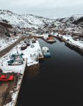 Moored boats in a snowy bay — photo by Erik Mclean on Pexels