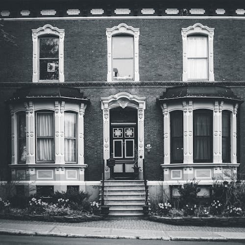 Facade of classic building with flowerbeds