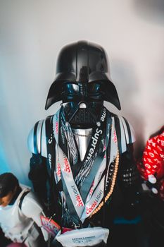 From above of villain character in helmet and stylish modern outfit placed on shelf at home