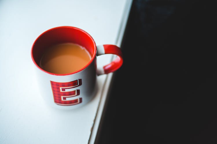 Cup Of Coffee With Milk On White Table