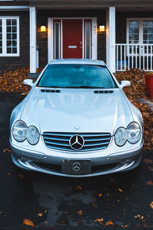 Silver Mercedes Benz Car Parked Near White and Red Building