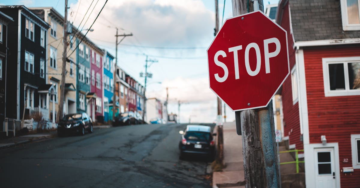 Colorful urban street scene with a prominent stop sign in the foreground.