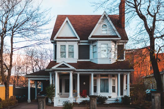 Elegant Victorian home exuding charm with its classic architectural features, set amid autumn foliage.