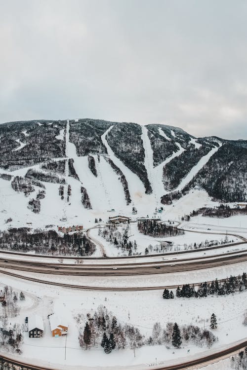 Snow Covered Mountain Under Cloudy Sky